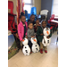Four children with their mother pose with 3 stuffed snowmen