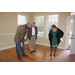 Three people inspecting the hardwood floors