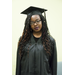 A girl wearing glasses in a cap and gown with curly hair