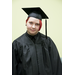 A young person with red hair in their cap and gown
