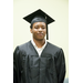 A young man posing in his cap and gown