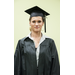 A young lady with large hoop earrings, in her cap and gown